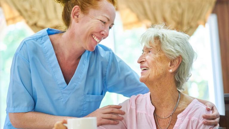 A caregiver and an old woman in an aged care center