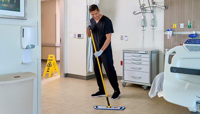Man cleans using Rubbermaid HYGEN microfiber mop in hospital setting
