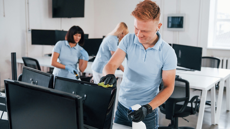 Group of working cleaning the monitor using the HYGEN™ Microfibre Cloth